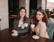 two female friends drink coffe restauratn speak beautiful women metting cafe end quarantine two female friends drink 184893249